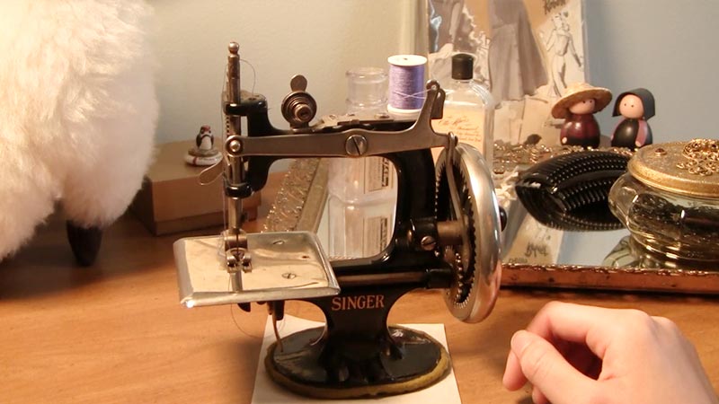 What Is the Historical Significance of Bobbins in Antique Toy Sewing Machines